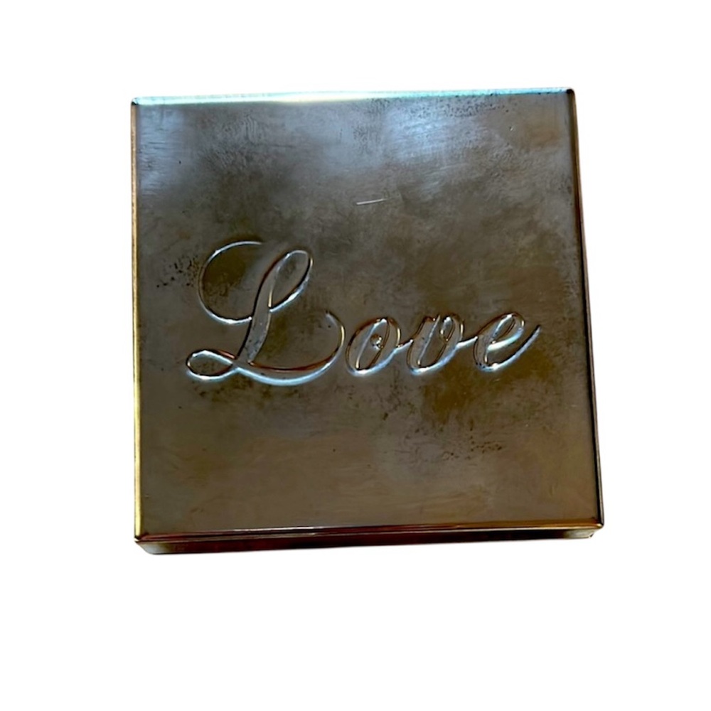 Square silver jewelry box with black lining and “Love” engraving